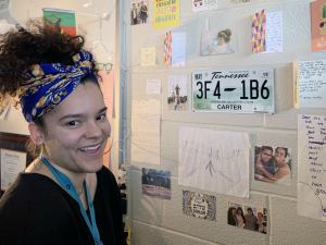 TeachHouse Fellow Brianna Tuscani smiling in front of cards she received from her students in her classroom at Jordan High School. 