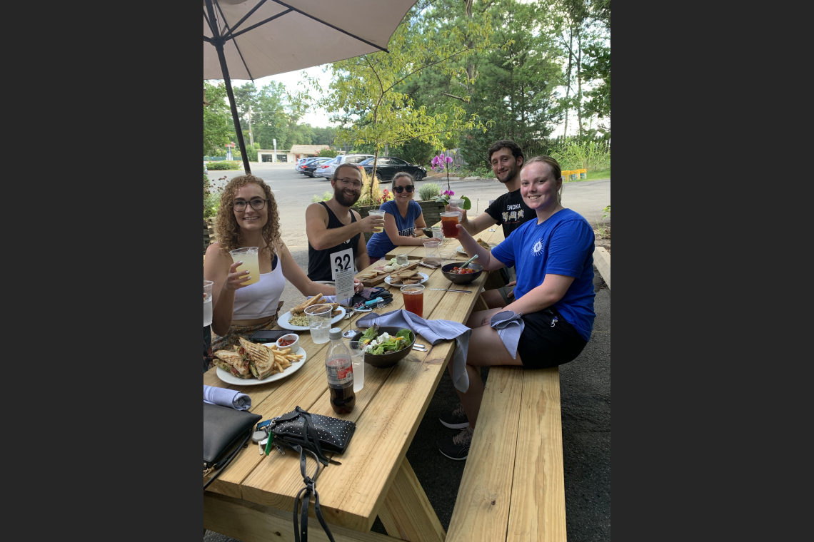people eating at picnic table