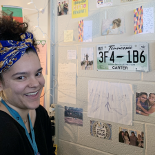 TeachHouse Fellow Brianna Tuscani smiling in front of cards she received from her students in her classroom at Jordan High School. 